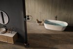 Comfortable bathtub and vanity with basin standing in modern bat