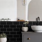 Real photo of a washbasin on a cupboard in a bathroom interior w